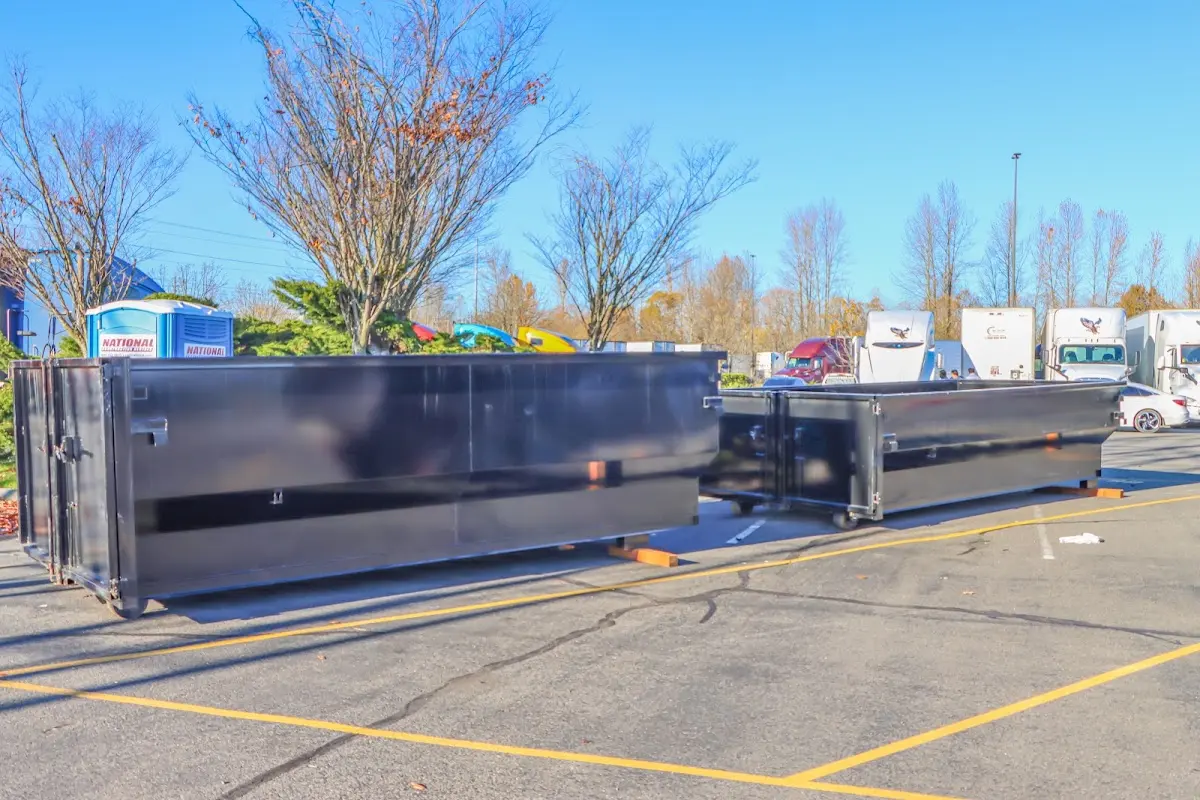 Professional dumpster rental service with roll-off container on residential driveway in Woodstock